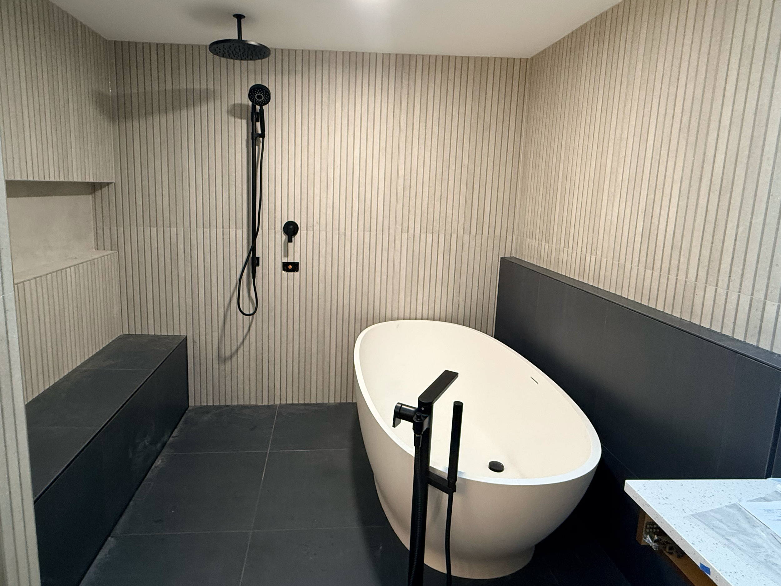 Neptune Plumbing bathroom remodel in Redmond WA featuring bathroom repiping, modern bathtub installation, shower replacement, and plumbing upgrade