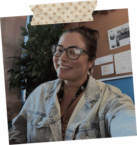 Drea smiling in a denim jacket