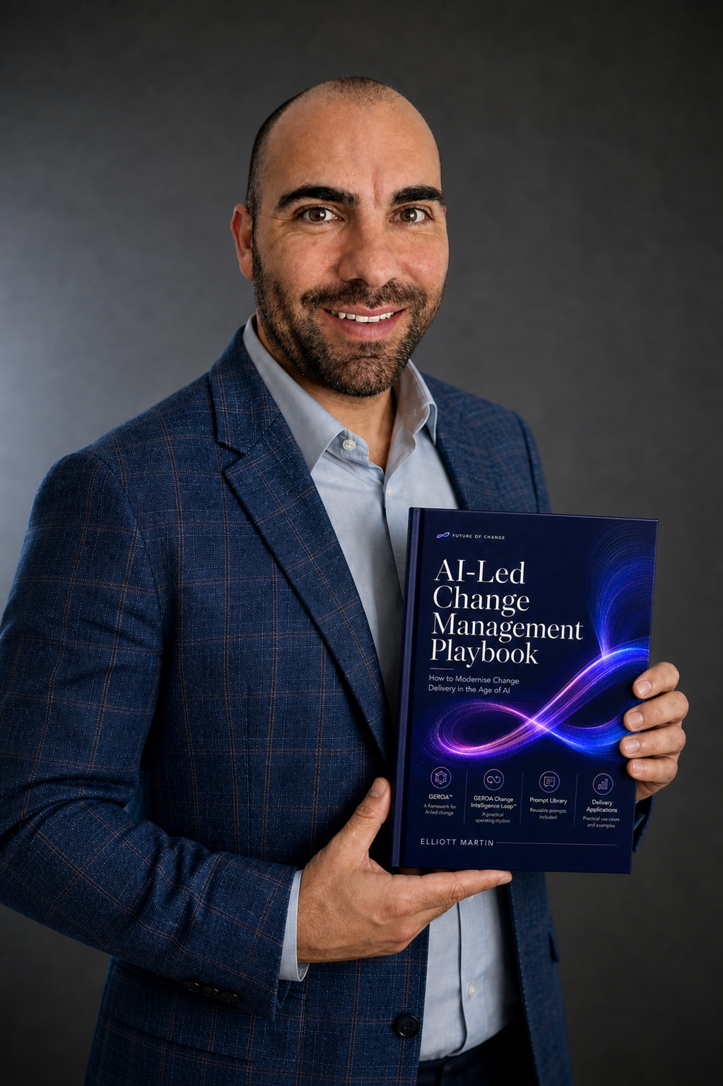 Elliott Martin holding the AI-Led Change Management Playbook