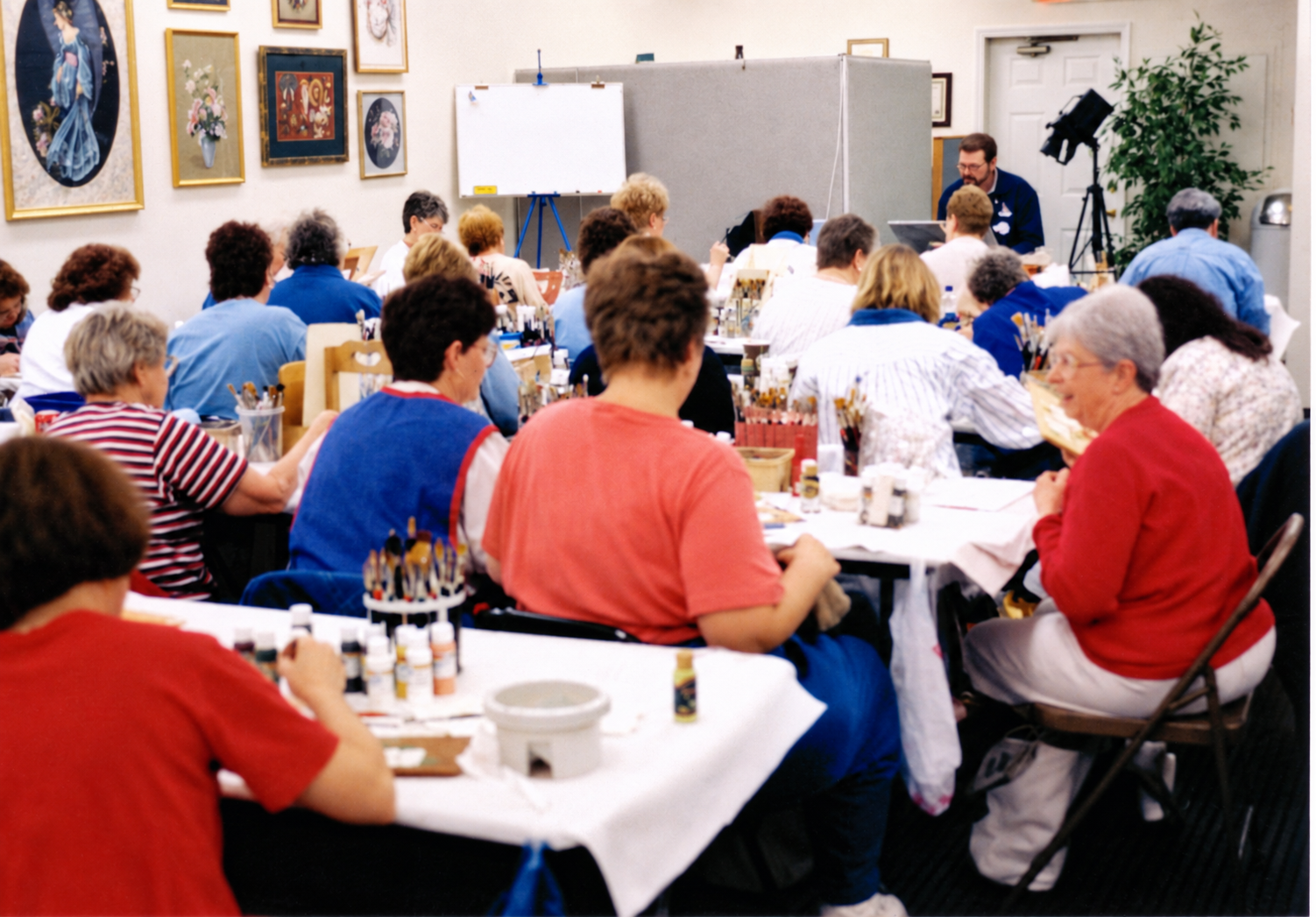 David teaching students at Master Pieces, with a closed-circuit camera beside his table.