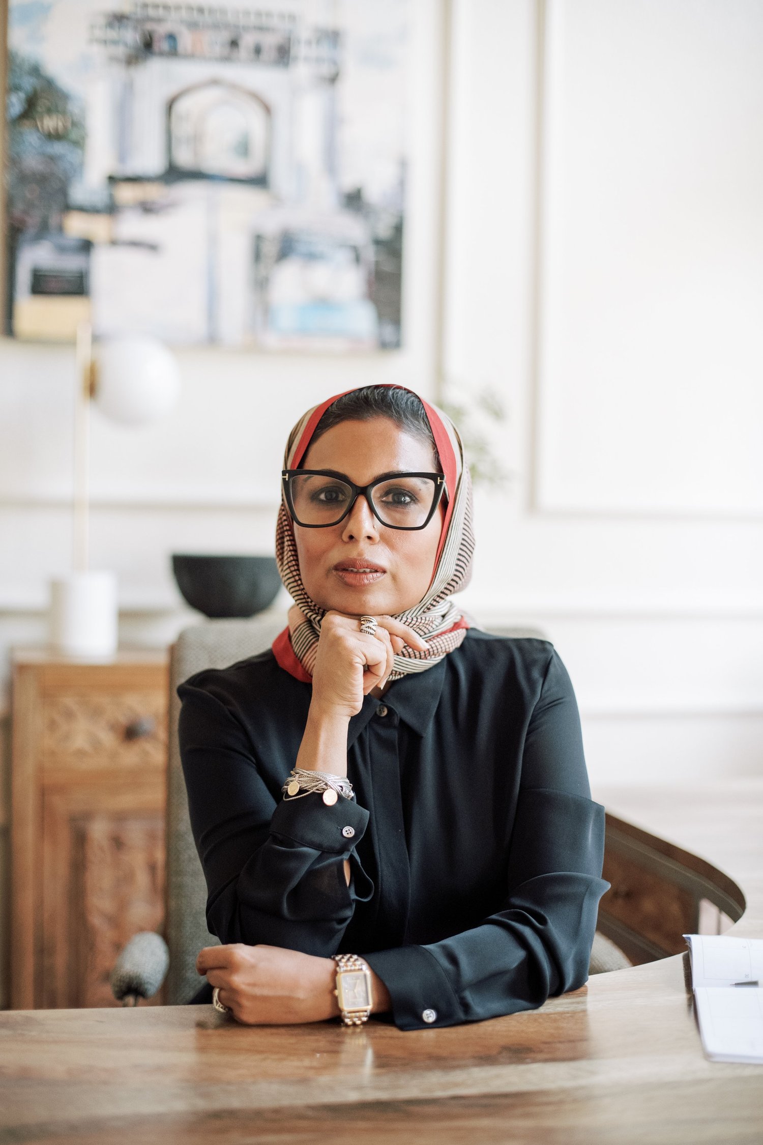 Dr. Farooqi seated at her desk, hands folded