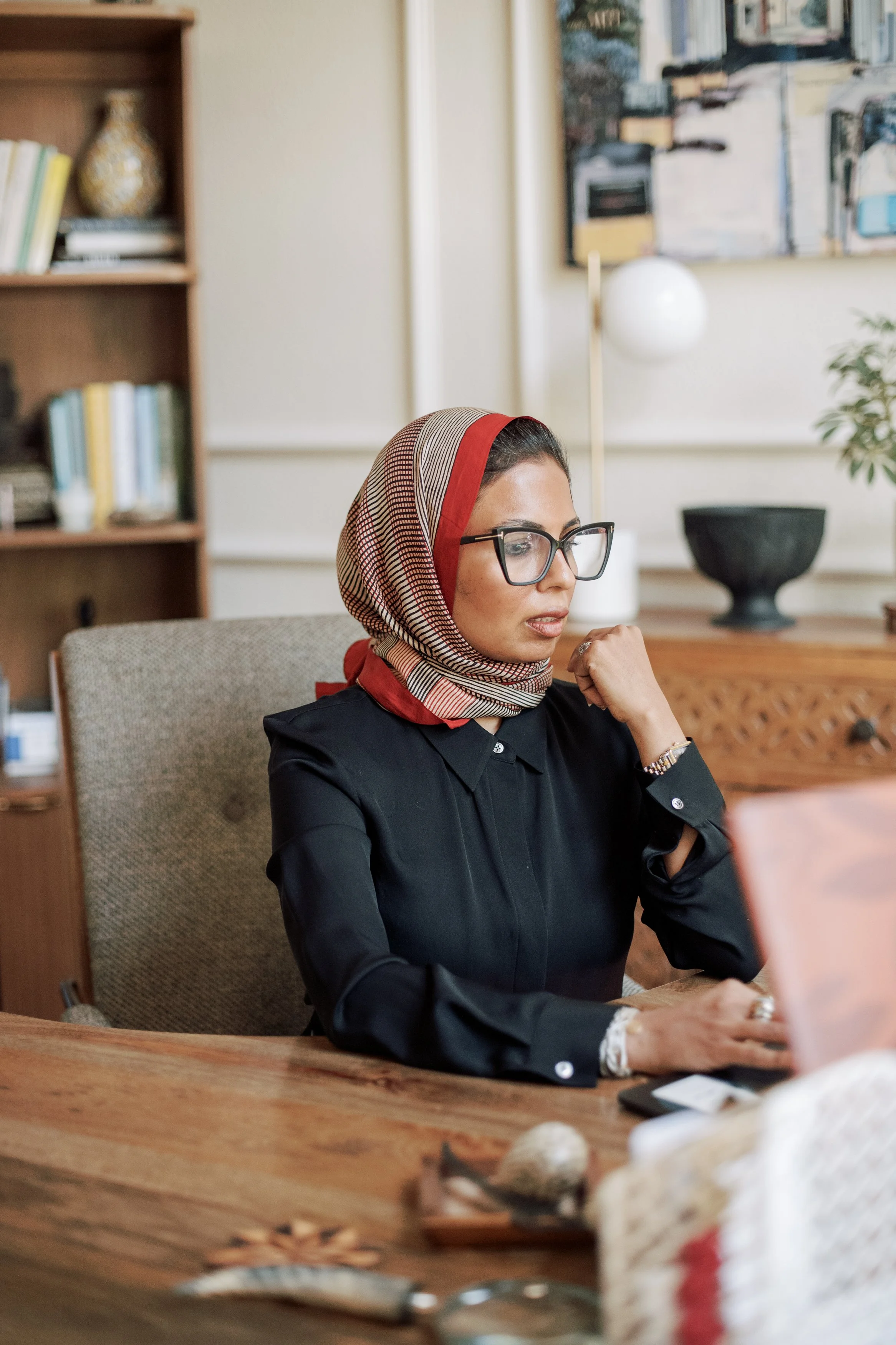 Dr. Farooqi at her desk, reviewing notes