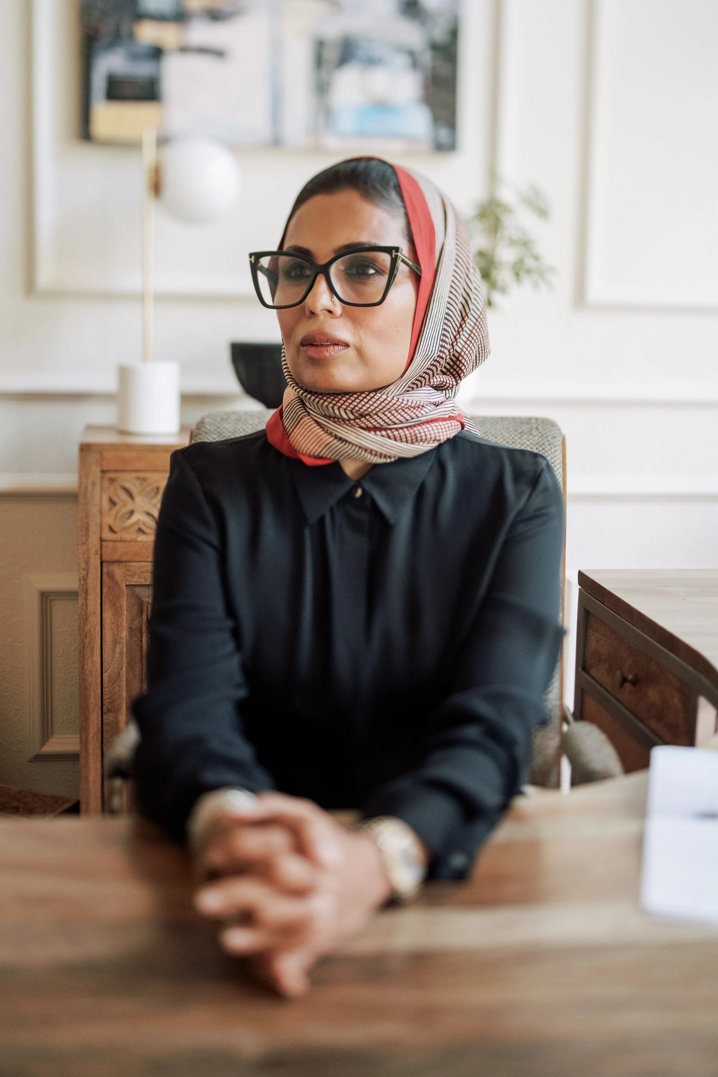 Dr. Mariya Farooqi seated at her desk in her practice