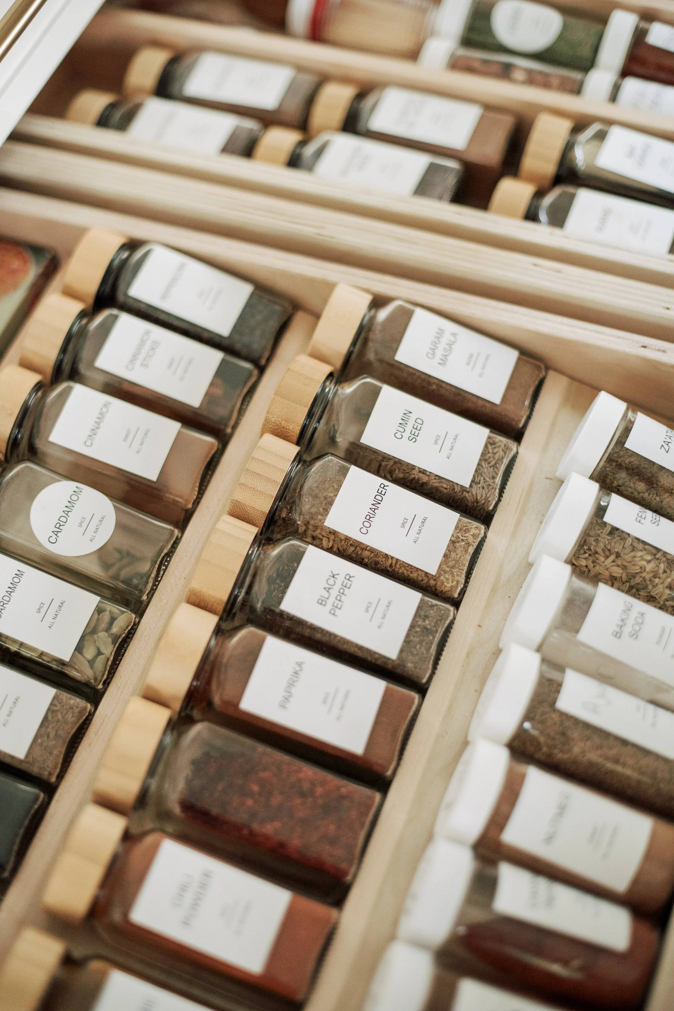A drawer of neatly labelled spice jars