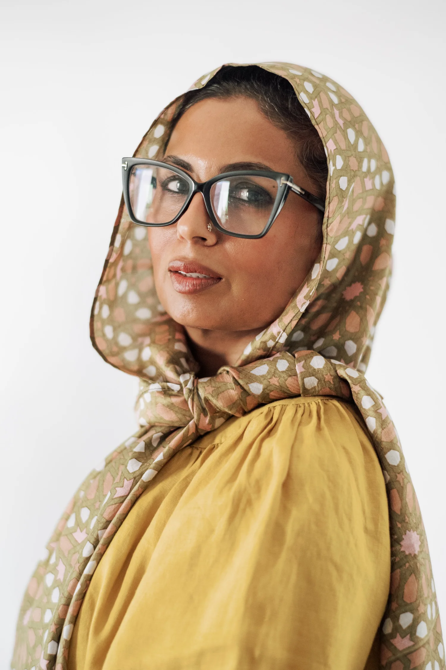Portrait of Dr. Mariya Farooqi in glasses and a patterned headscarf