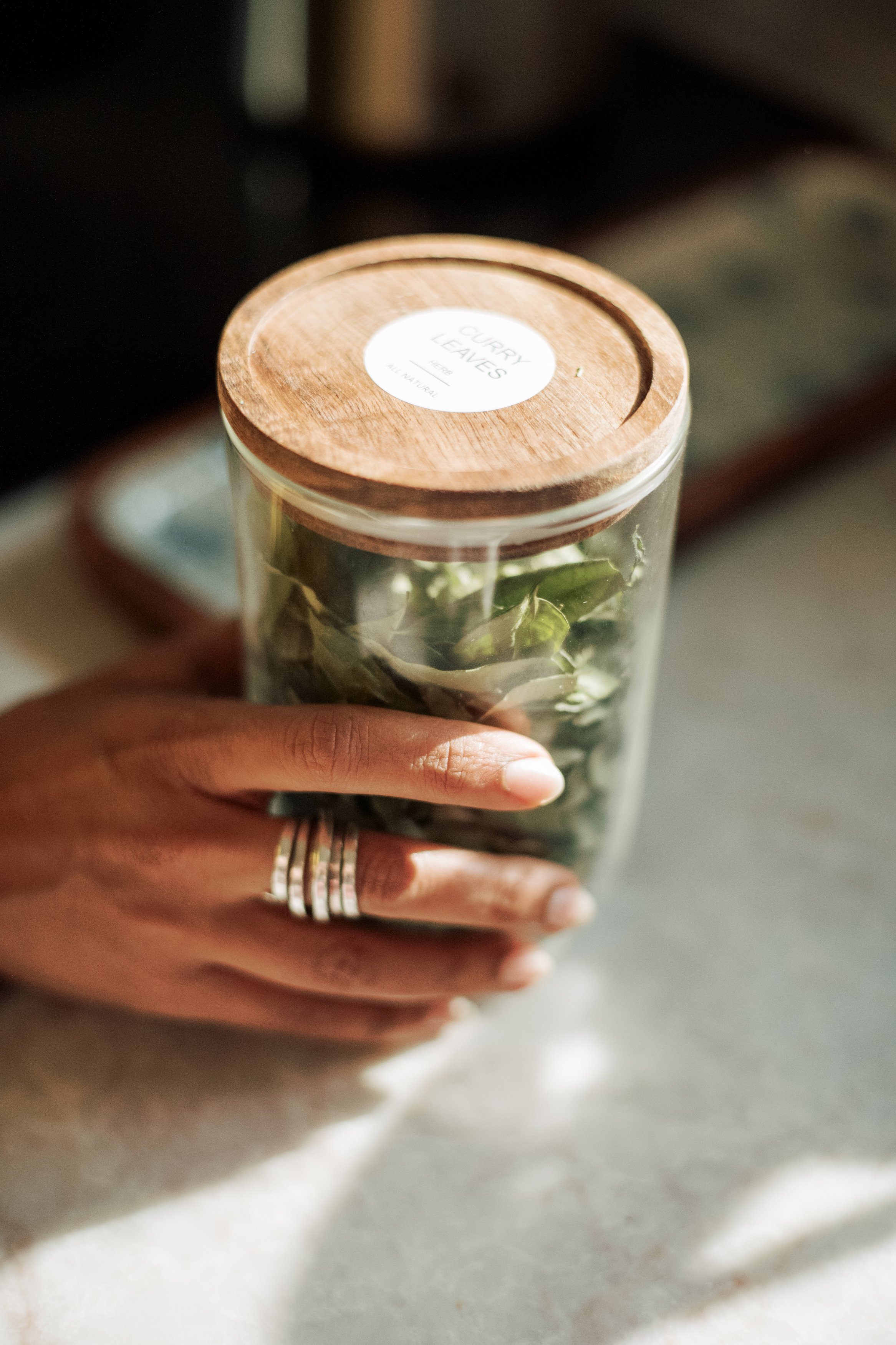 Dr. Farooqi holding a glass jar of fresh greens