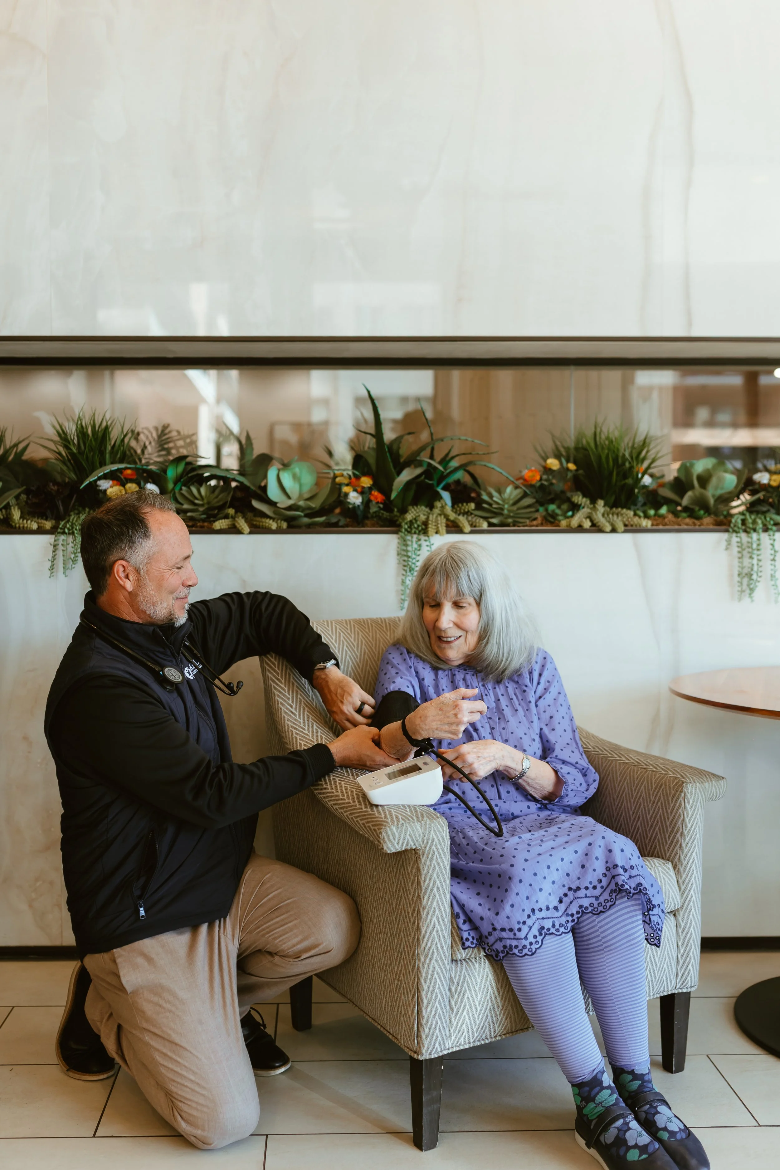 A clinician providing in-home care and guidance to an older adult