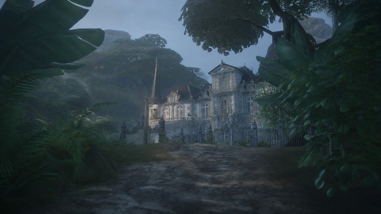 Misty garden path leading to grand facade of romantic old world mansion at dusk, Château de Lucille