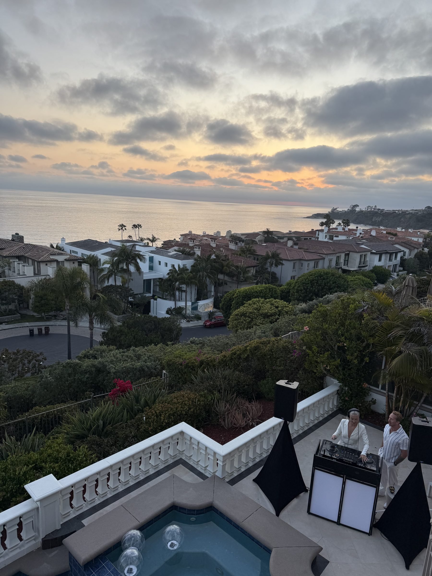 Red-tile-roof coastal homes above the Pacific at sunset in the Monarch Beach area of Dana Point