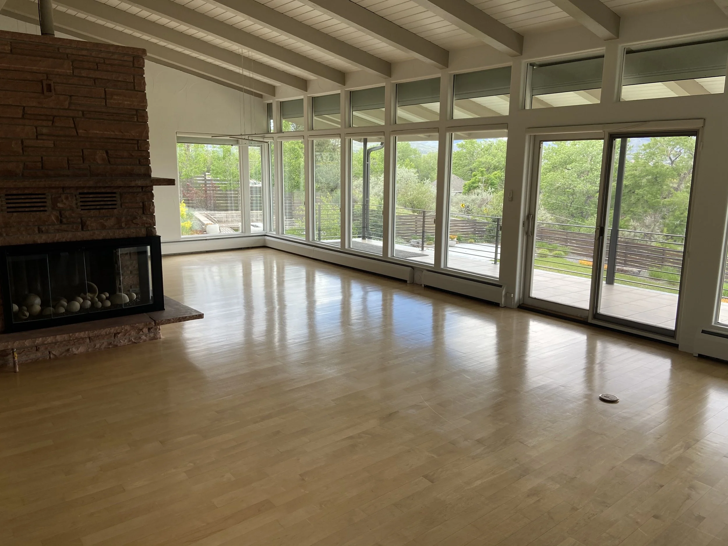 Empty living room after estate cleanout, hardwood floors and fireplace, Northern NJ