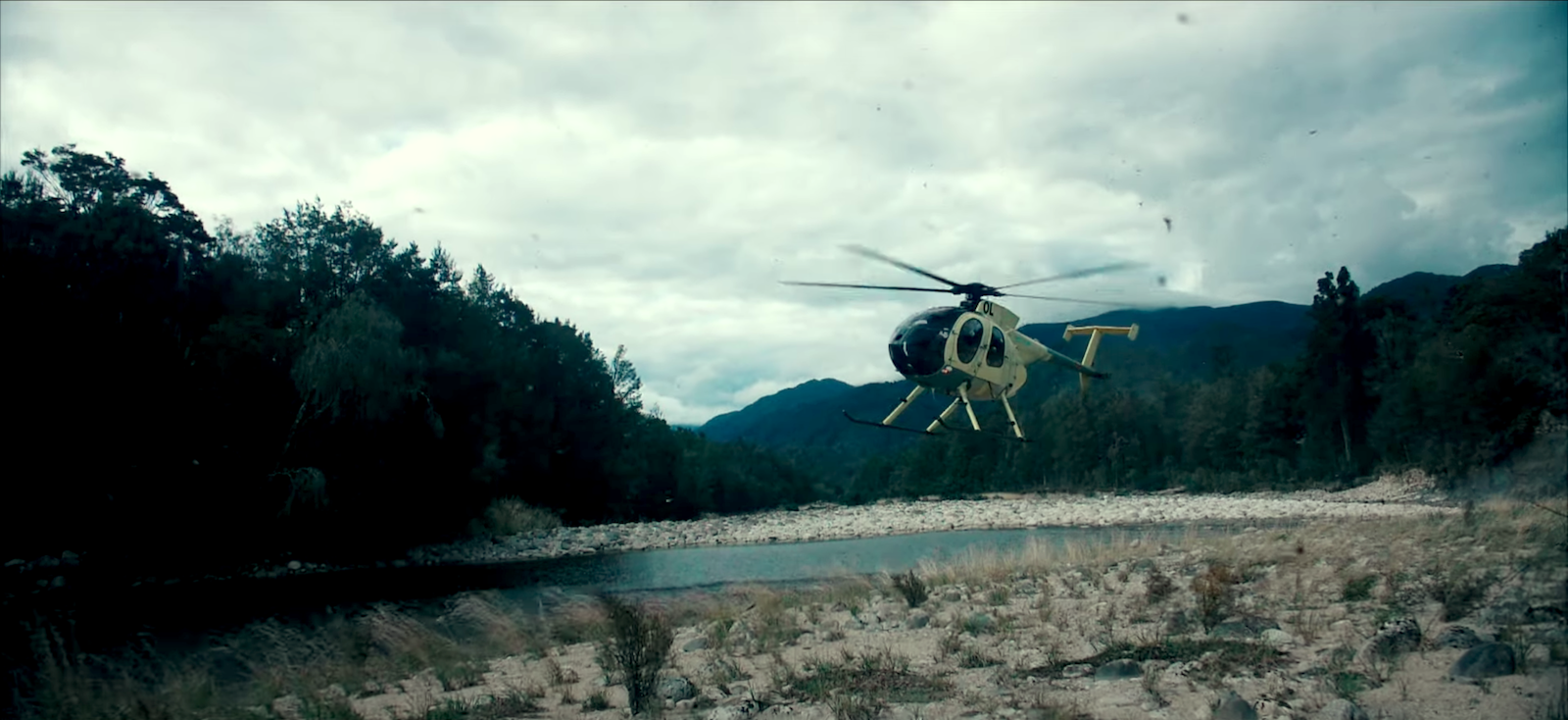 A helicopter departing a remote river valley in New Zealand’s South Island