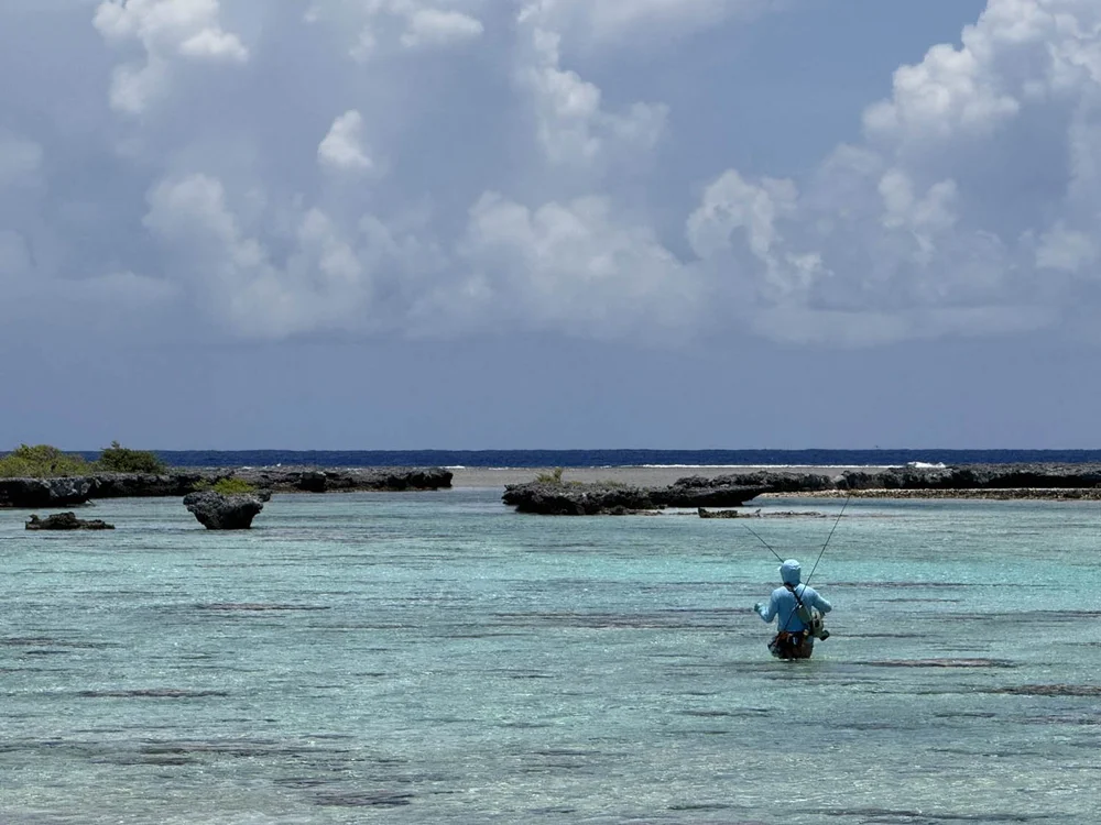 An angler wading the shallow reef flats on Tikehau