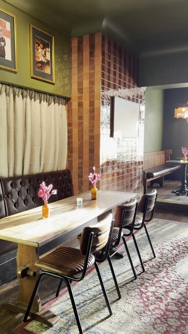 Long table with leather chairs in the refurbished Snug