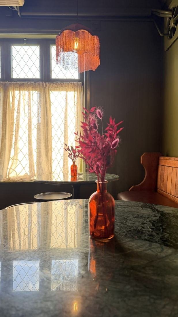 Marble table by the leaded window in the Snug