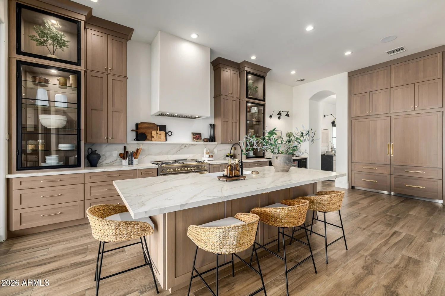 Remodeled kitchen with white oak cabinets and a marble island in a South Chandler home