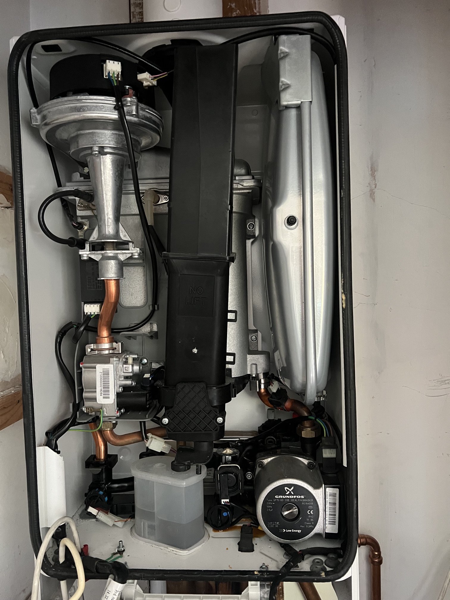 Ideal Logic combi boiler with the casing removed during its annual service, internal components visible for inspection