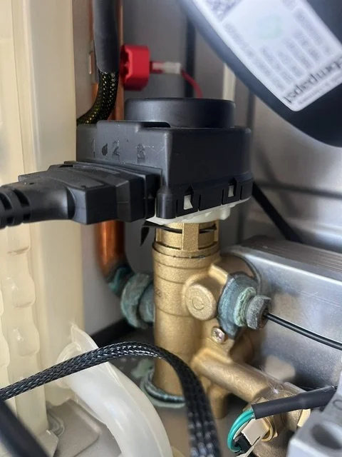 Diverter actuator from a Baxi combi boiler with the brass diverter valve body underneath