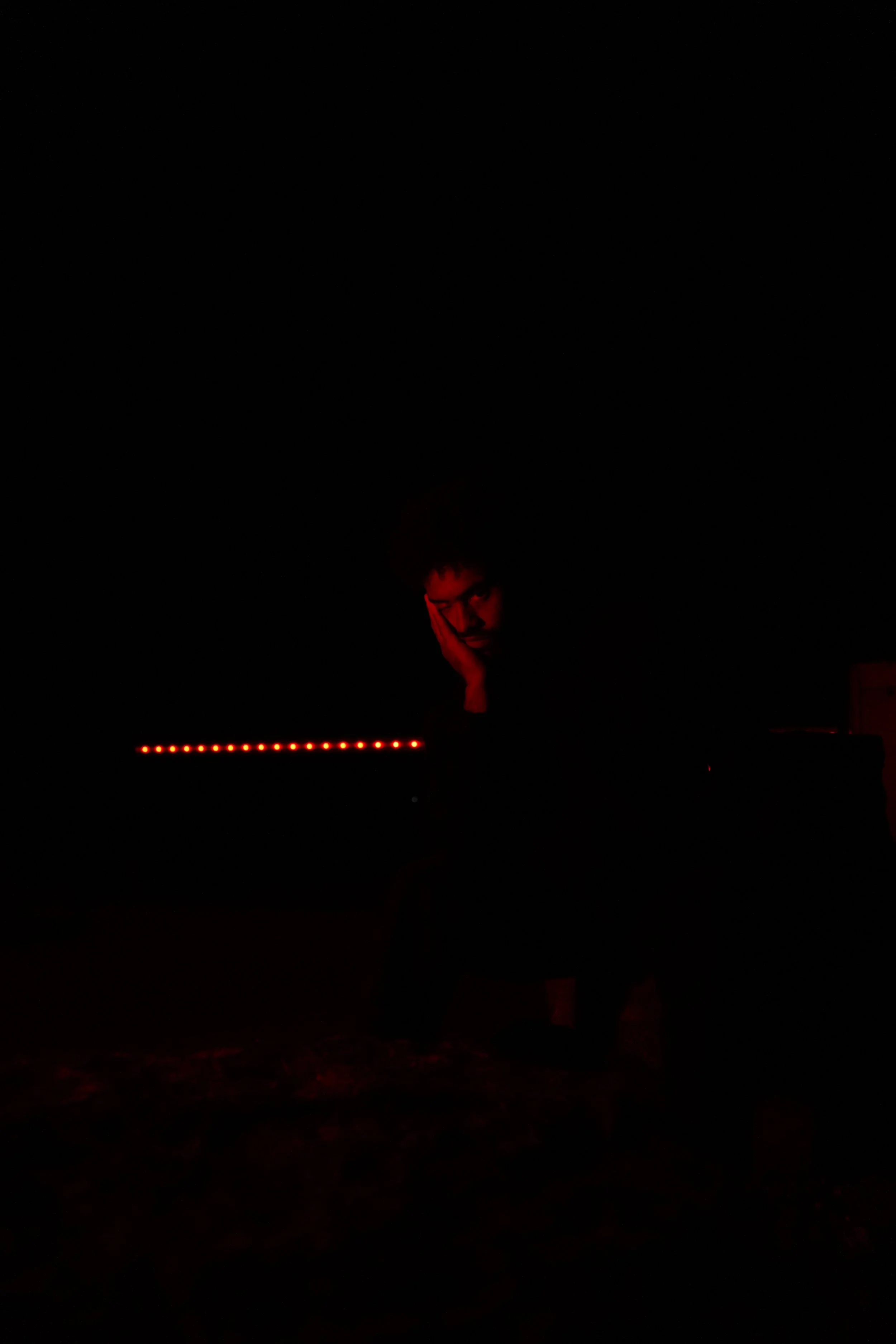 Portrait from Jordan Higo’s red-lit photography series