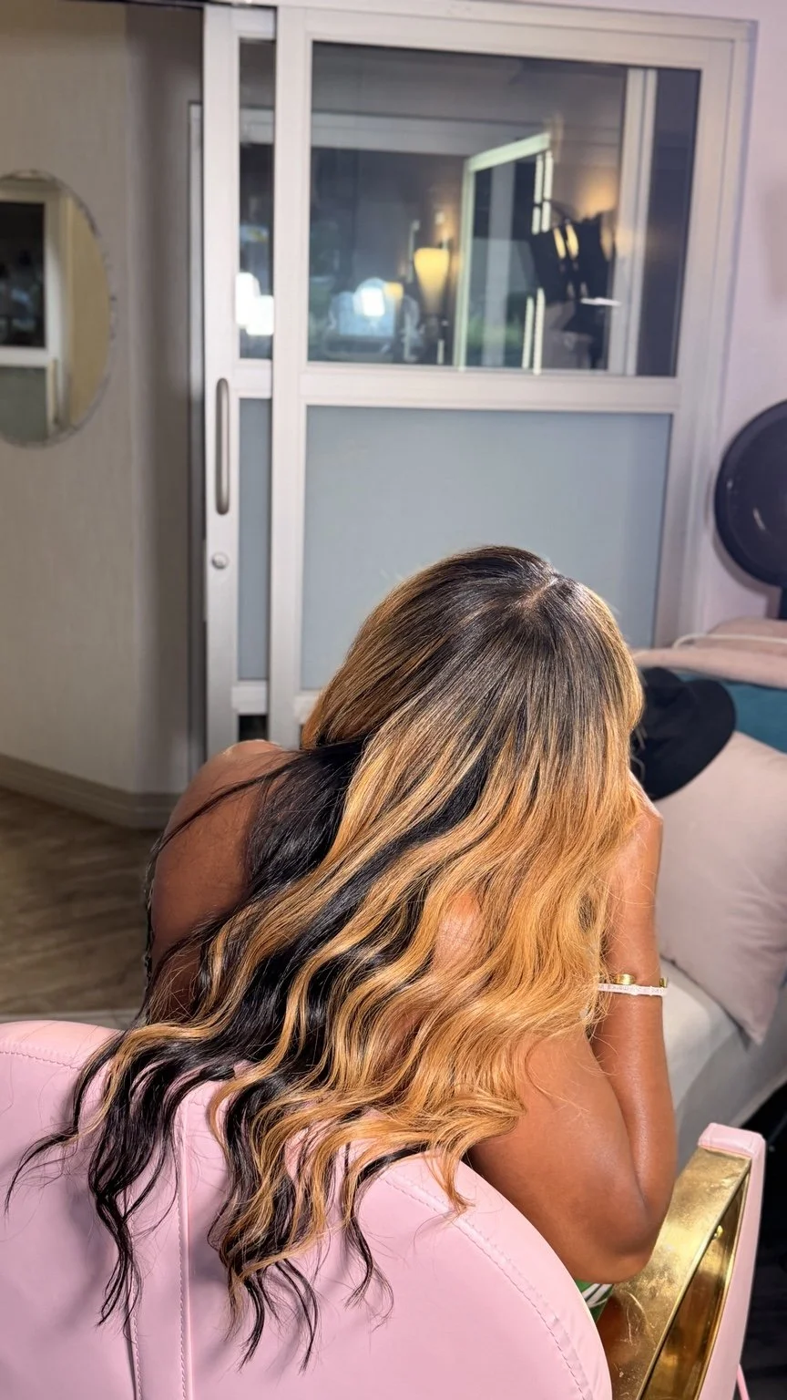 After: the same client with longer dimensional blonde waves and deeper tones