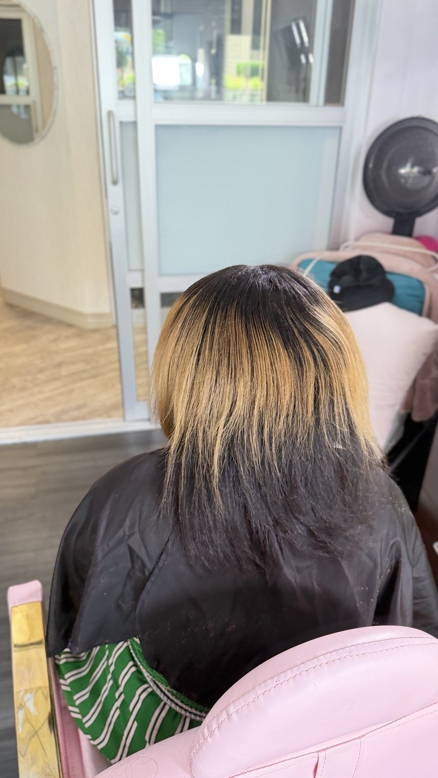 Before: shorter hair with dark and blonde color contrast, viewed from behind