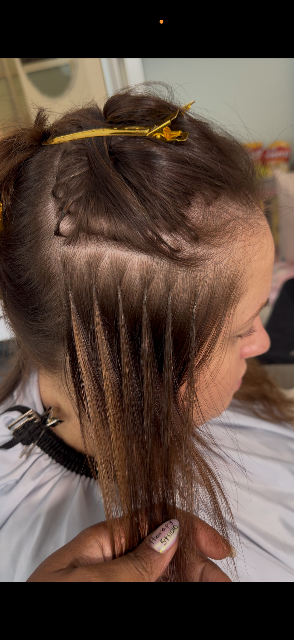 Close-up of individual extension attachments and sectioning at the side of the head