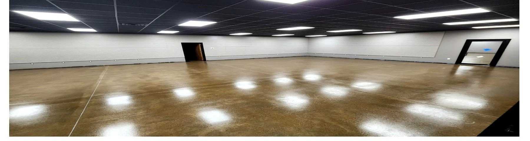Large open commercial space with warm polished concrete floor