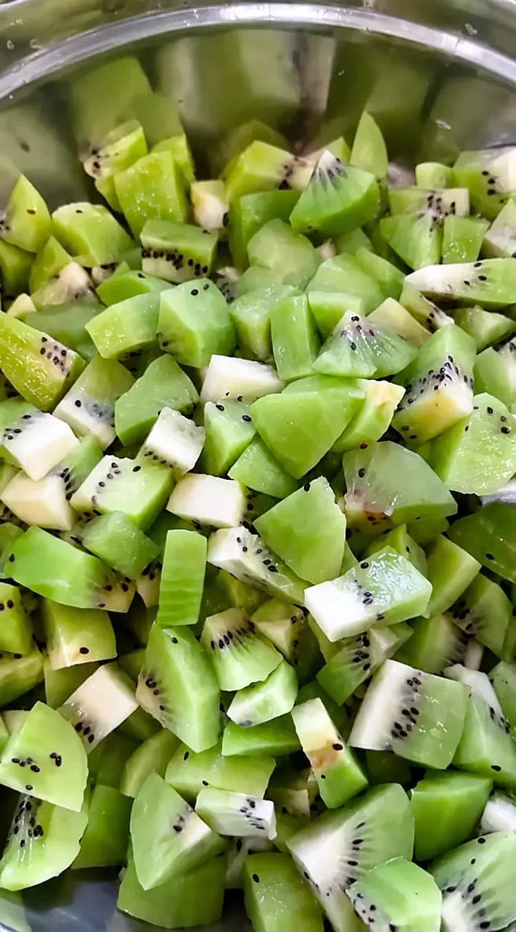 Fresh chopped kiwi in a preparation bowl