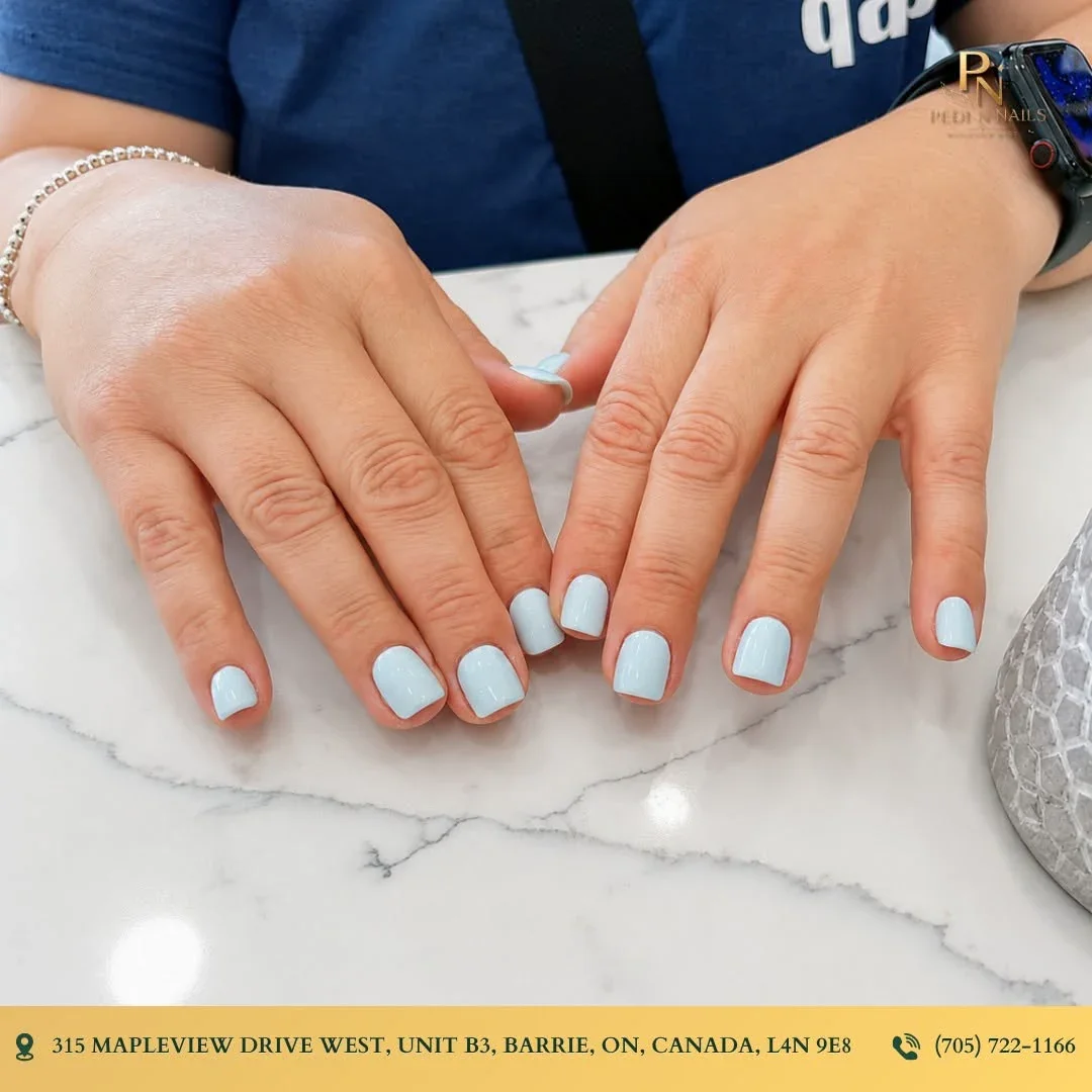 Short natural nails with soft blue polish at Pedi N Nails Mapleview West