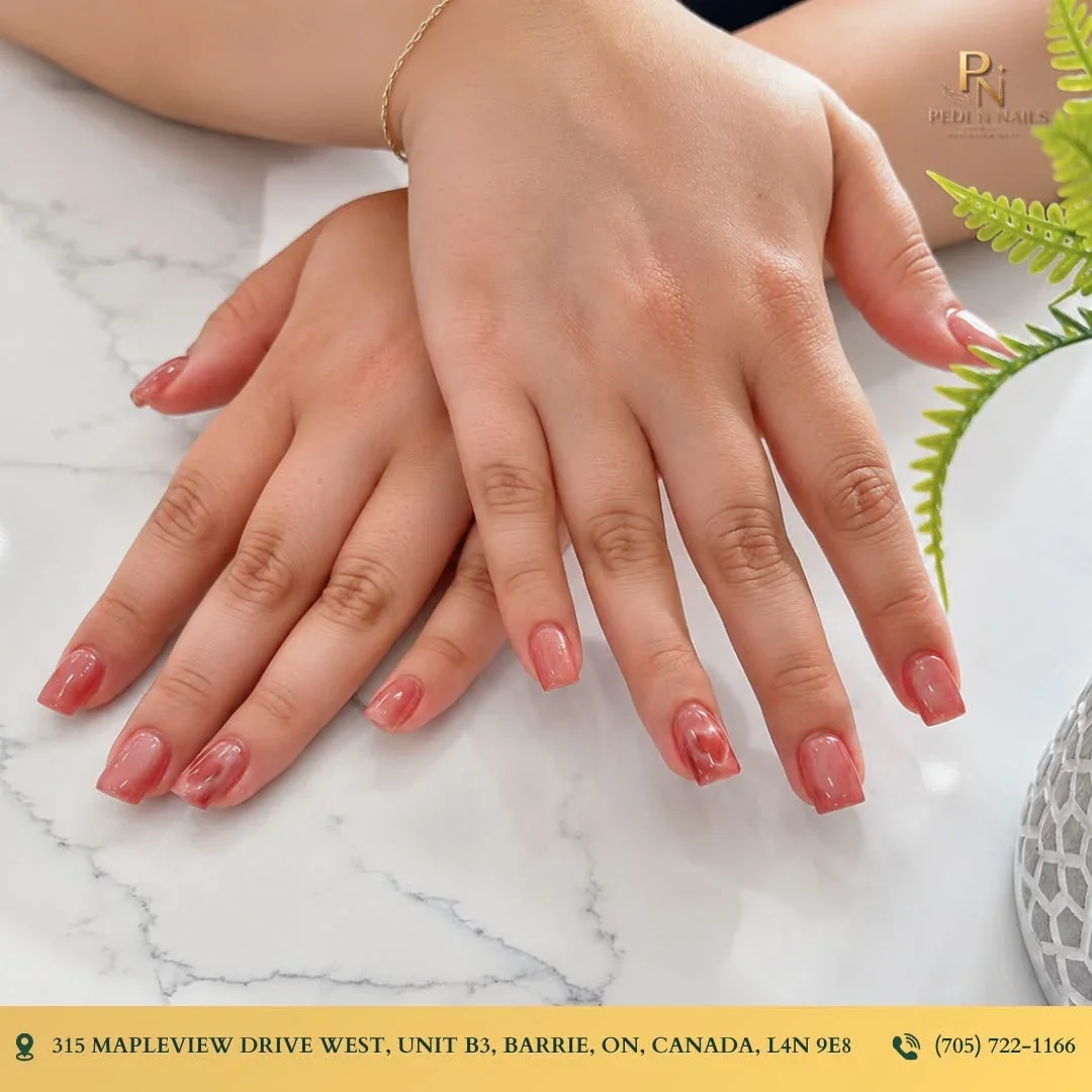 Short natural nails with coral polish at Pedi N Nails Mapleview West