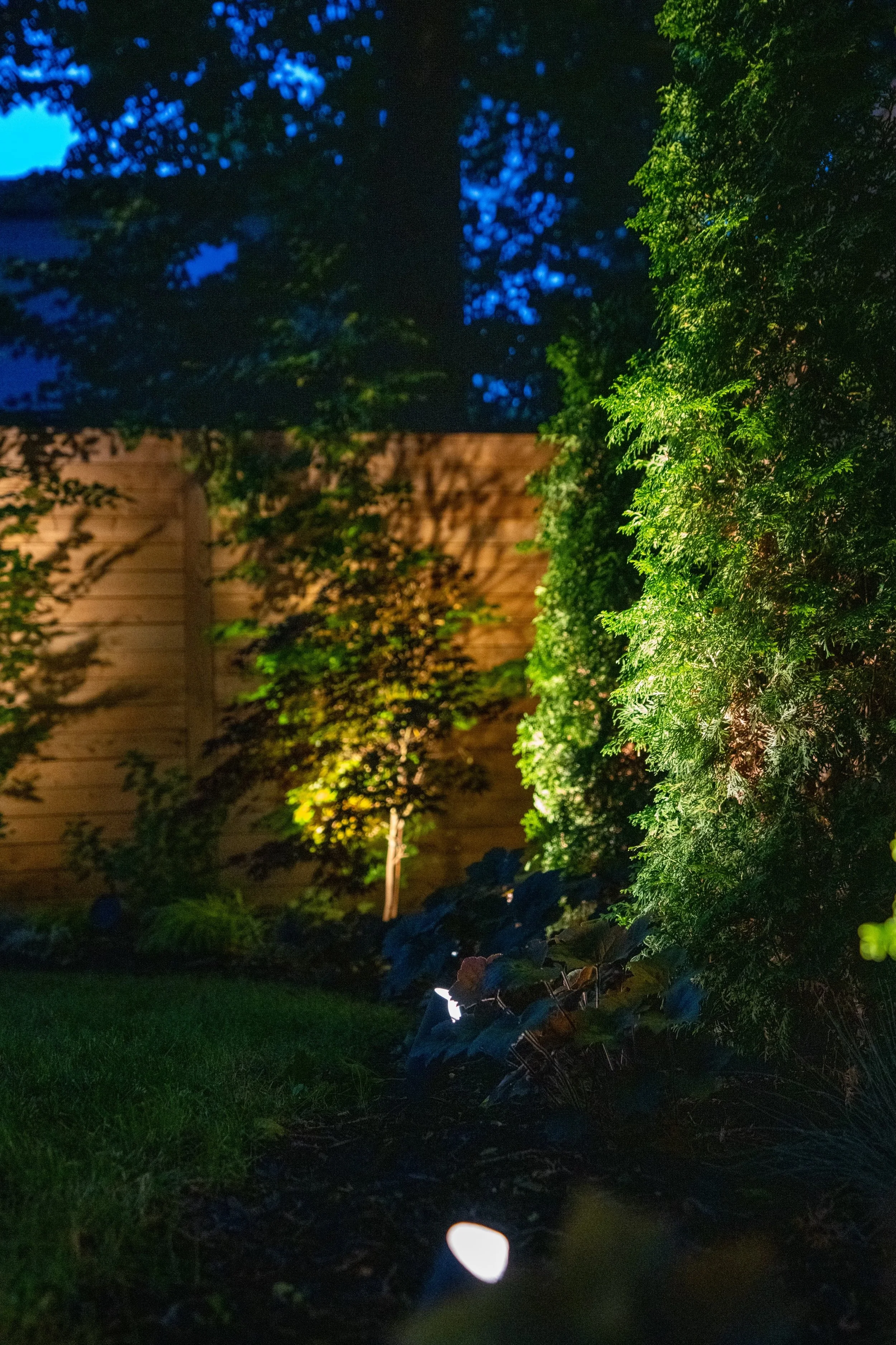 Courtyard seating and firepit lit warmly
