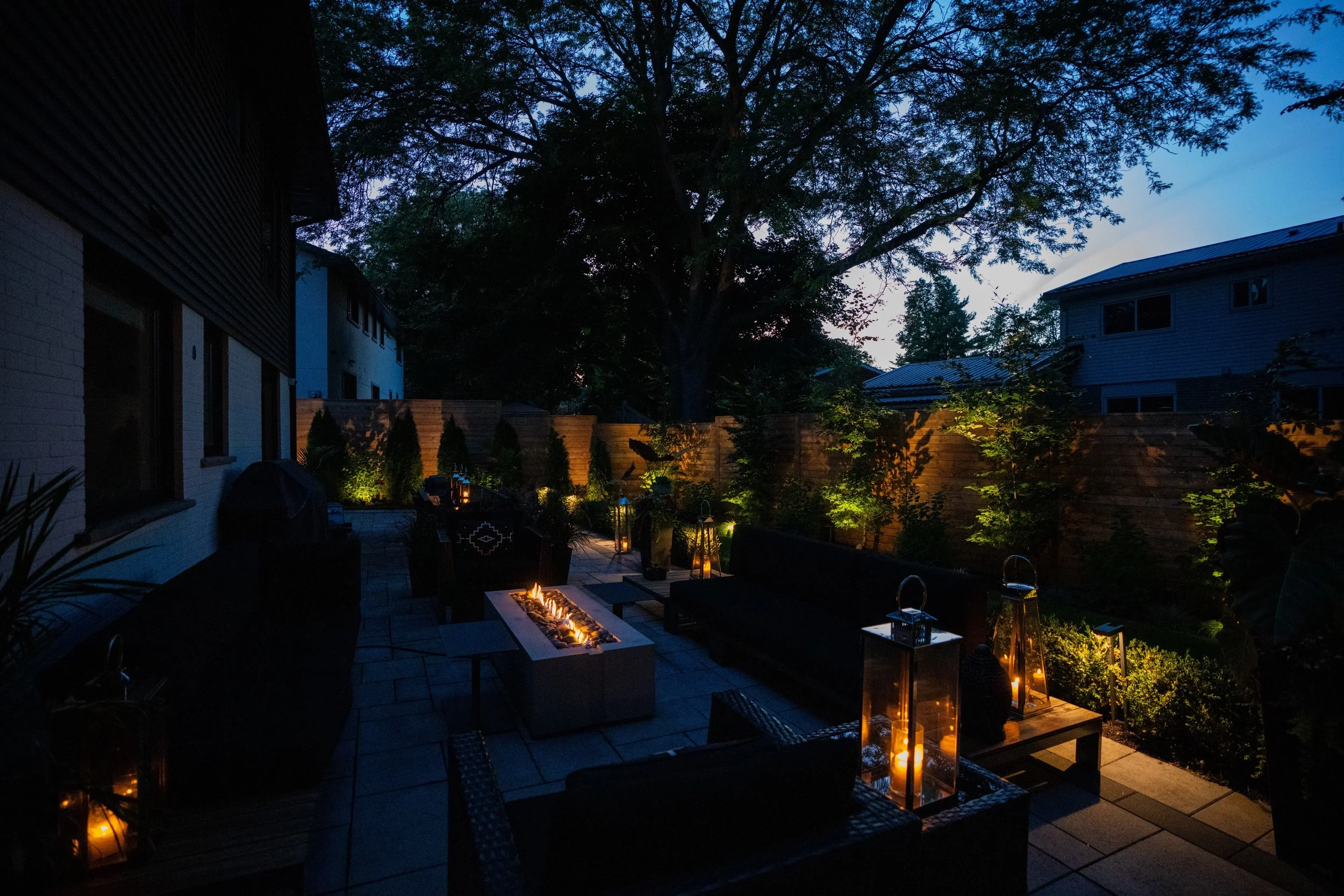 Courtyard seating and firepit lit warmly
