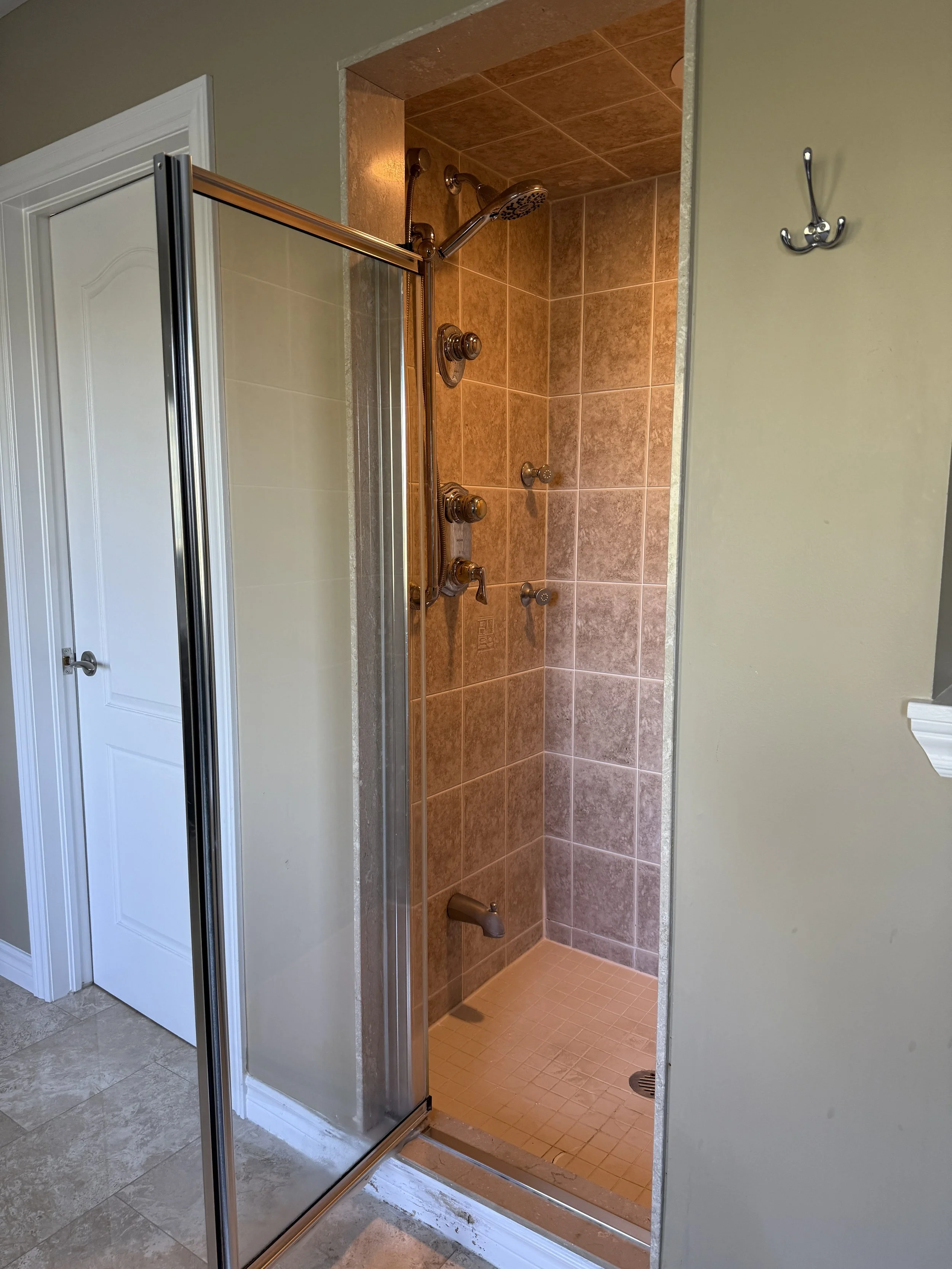 Bathroom before renovation, original layout and dated finishes