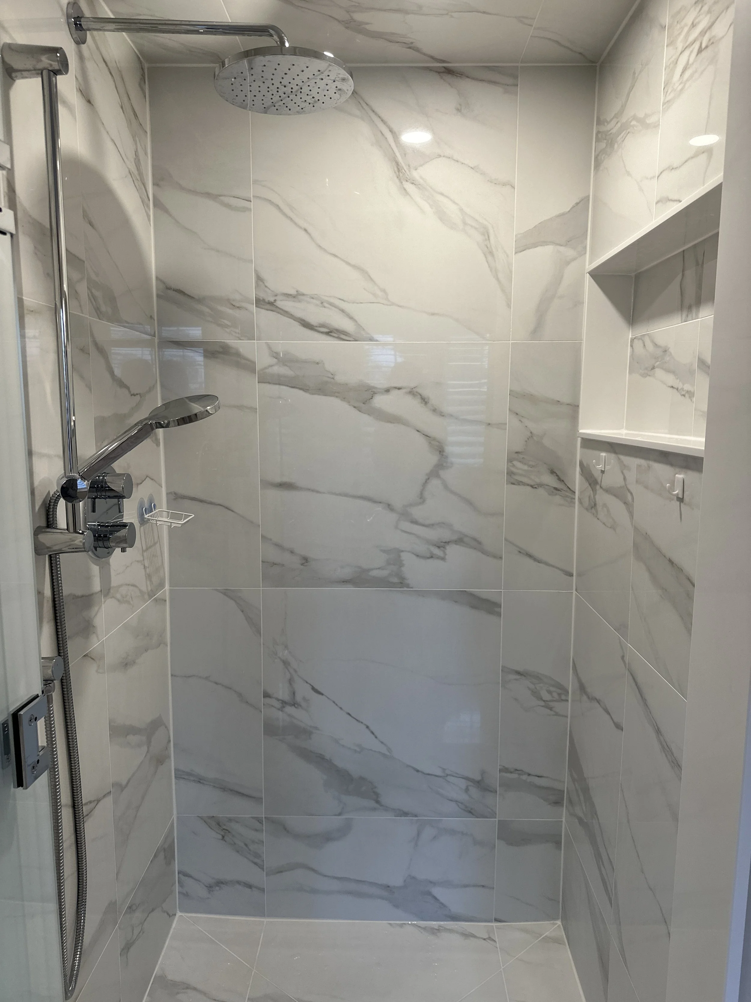 Bathroom delivered, large format tile and frameless glass