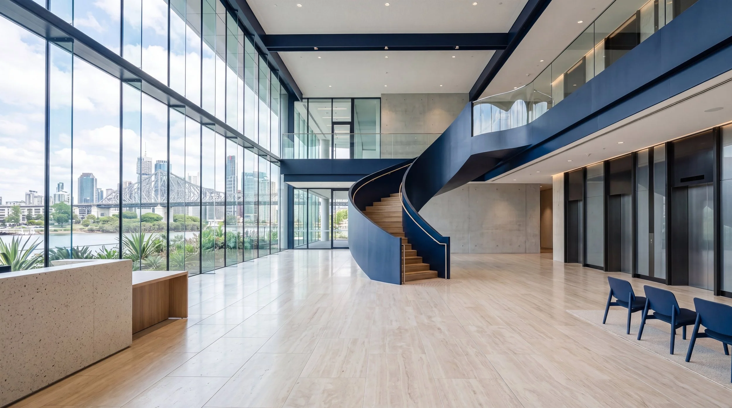 Light-filled modern Brisbane commercial building lobby with Brisbane River and Story Bridge views