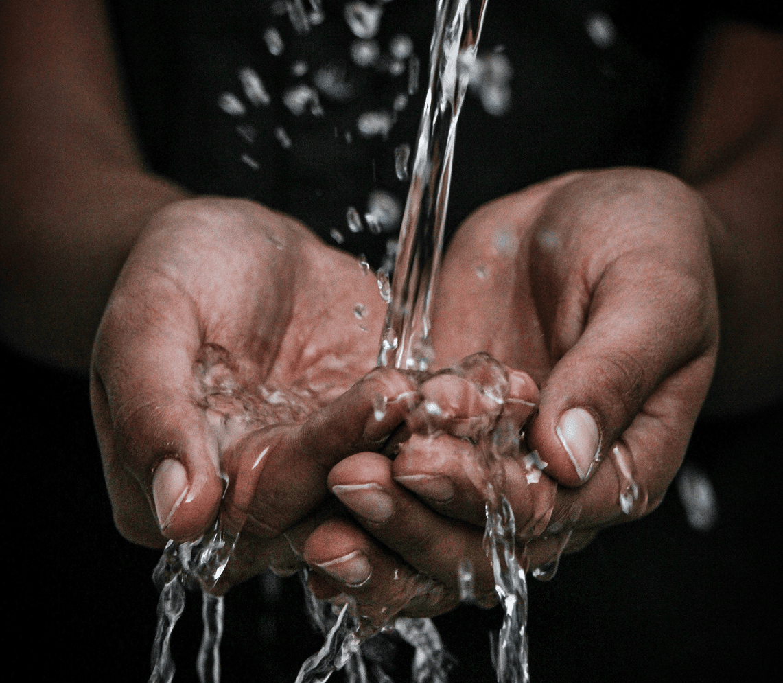 Water flowing into cupped hands