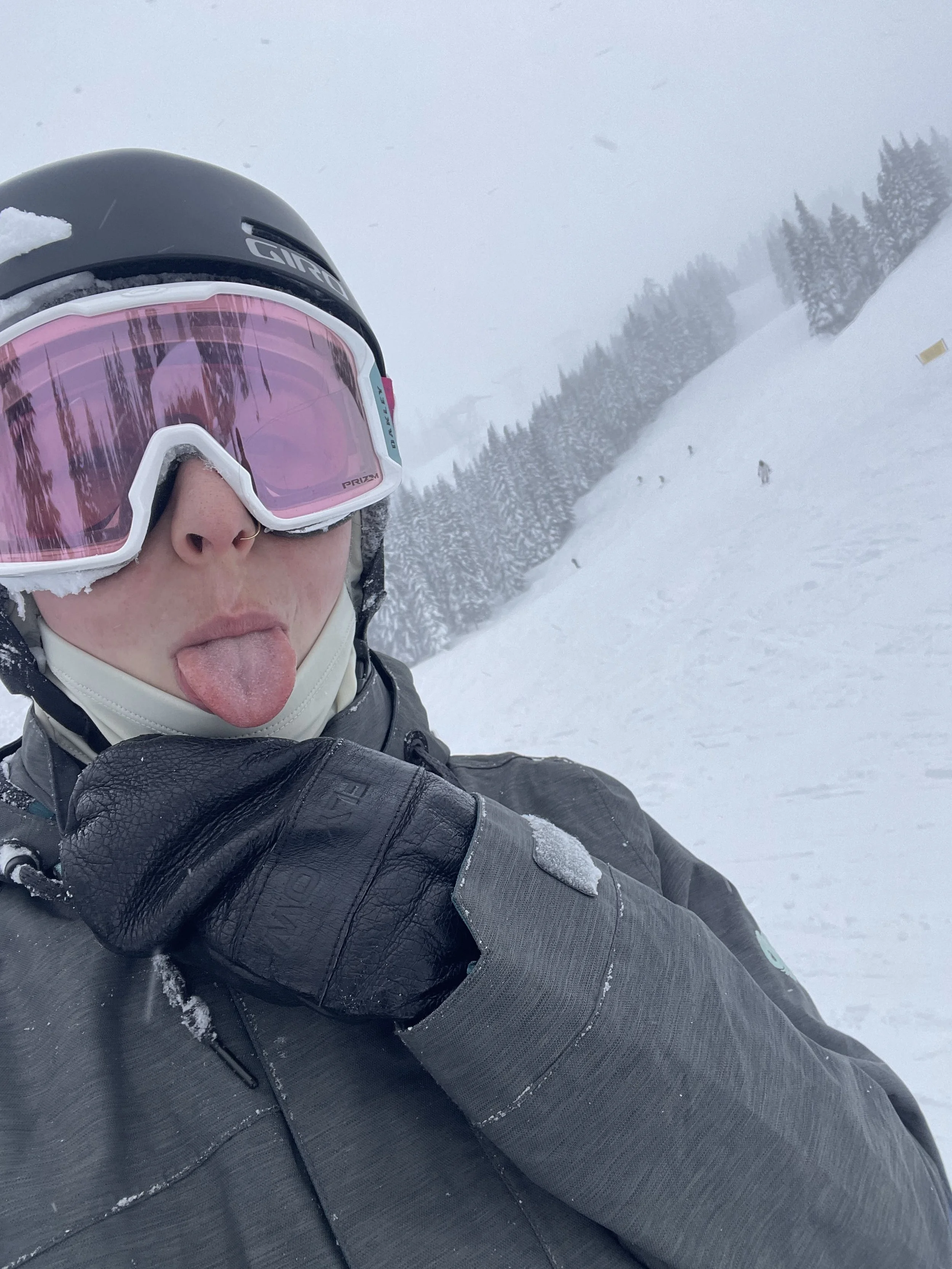 Ski selfie with pink goggles in fresh snow