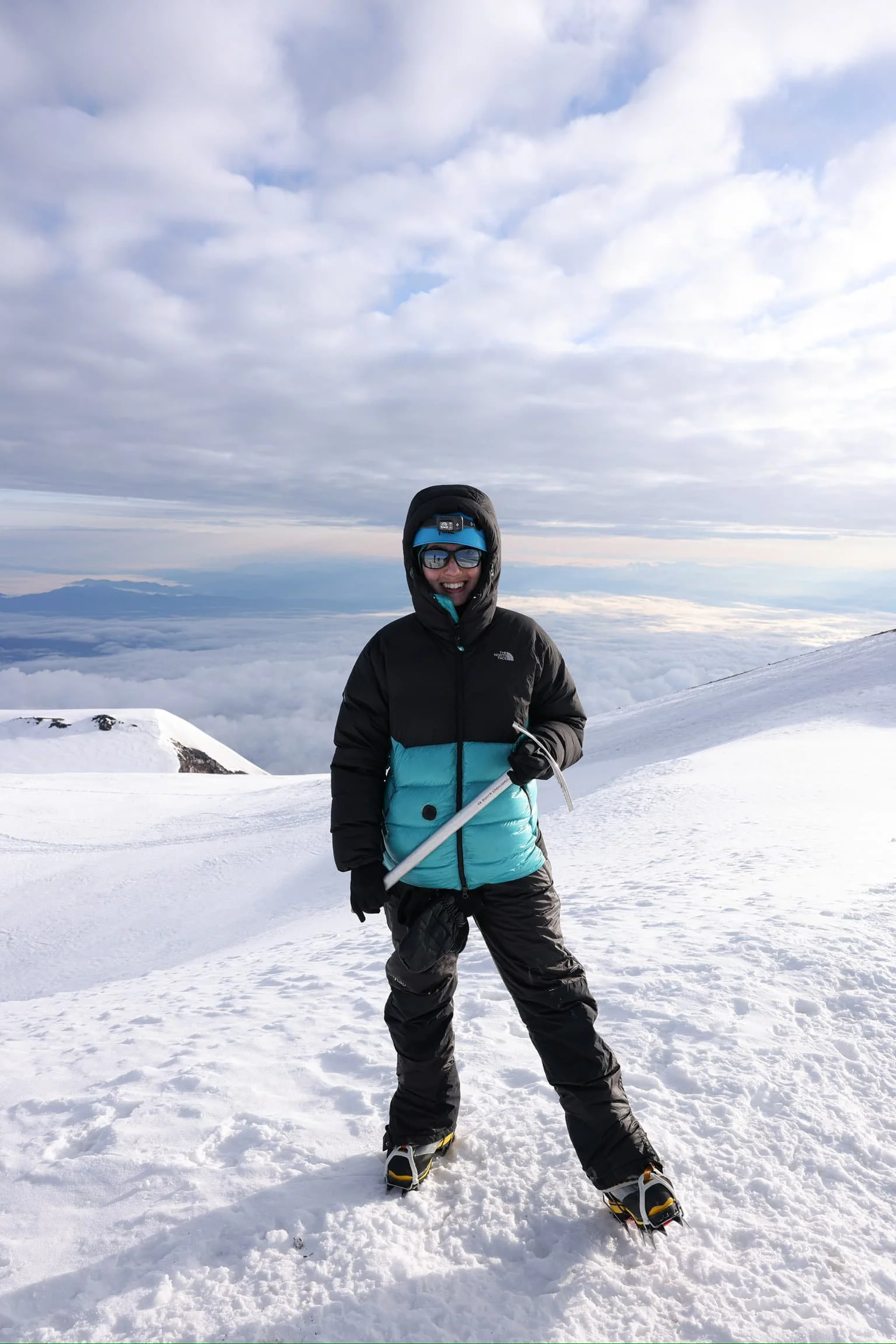 Rainier summit with ice axe above the clouds