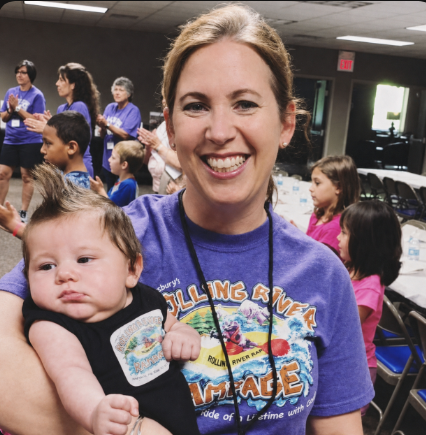 Elaine Pendergrass holding a baby at a children’s ministry event
