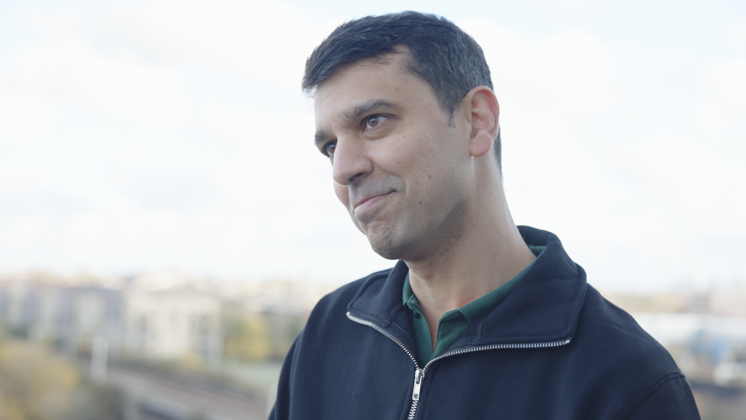 A member of the Wayve team smiling during filming.