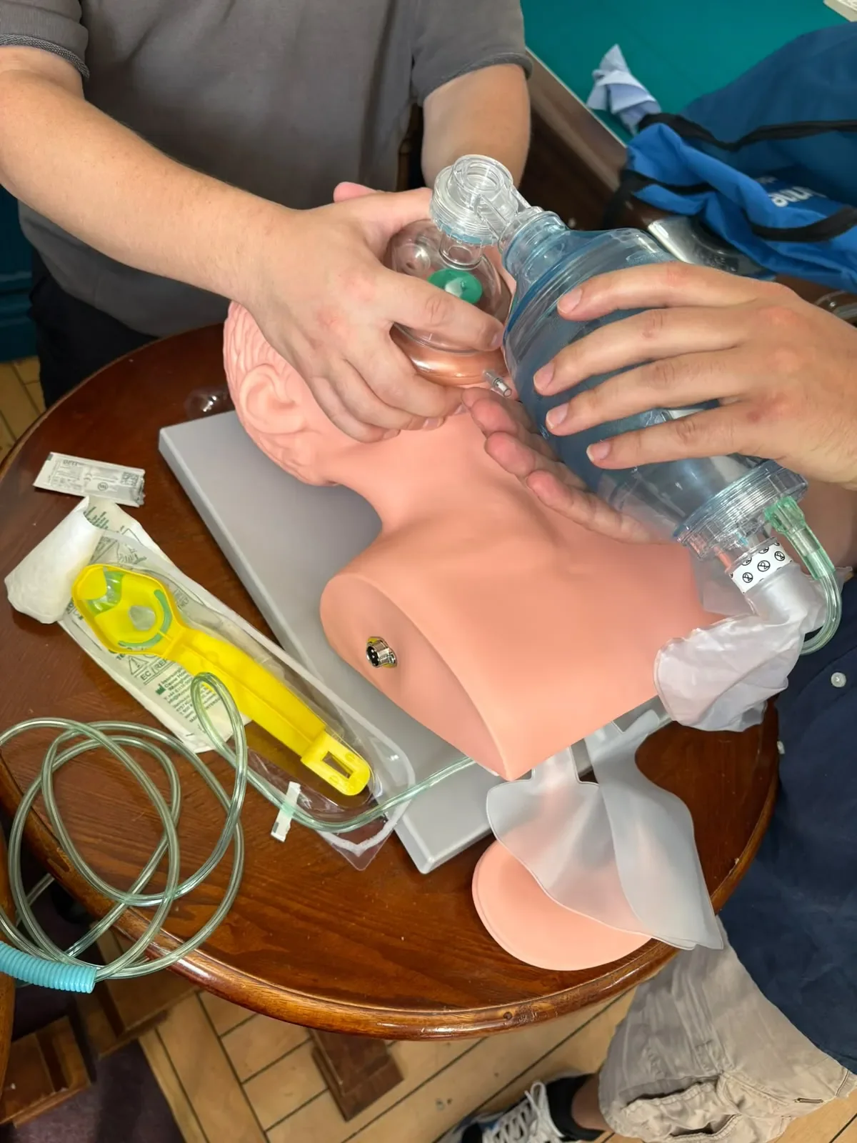 Learners practising bag-valve-mask ventilation on an airway training manikin