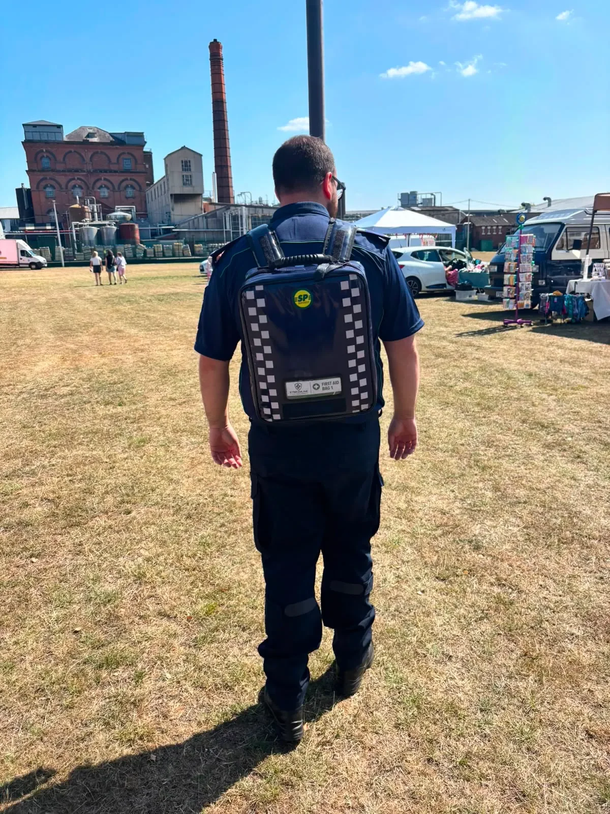 Streamline team member carrying a medical response backpack at an outdoor event