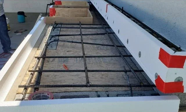 Rebar and formwork set before a concrete pour by Specialty Landscape