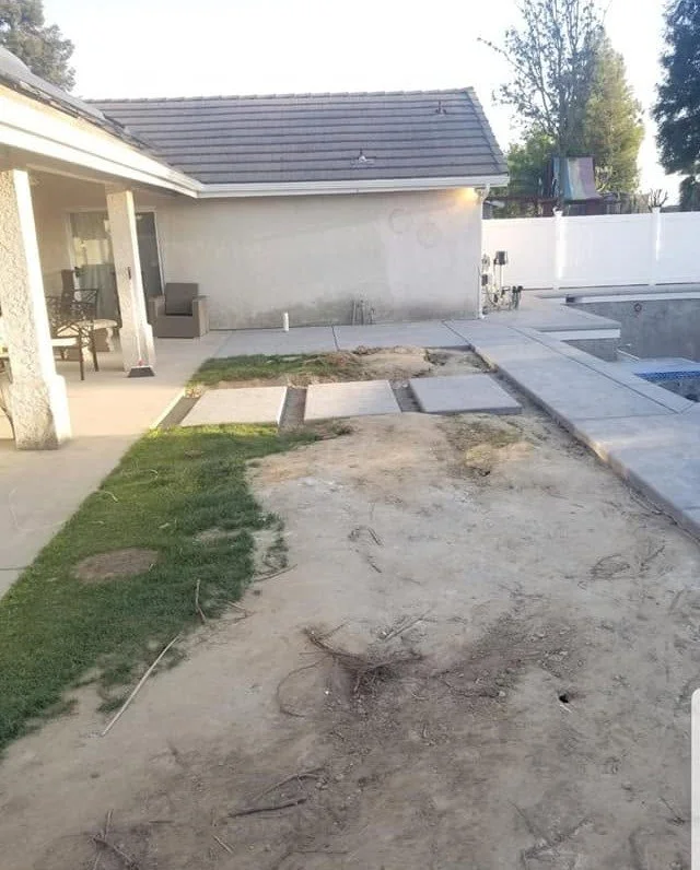 Tired backyard slab before a landscape renovation and redesign by Specialty Landscape
