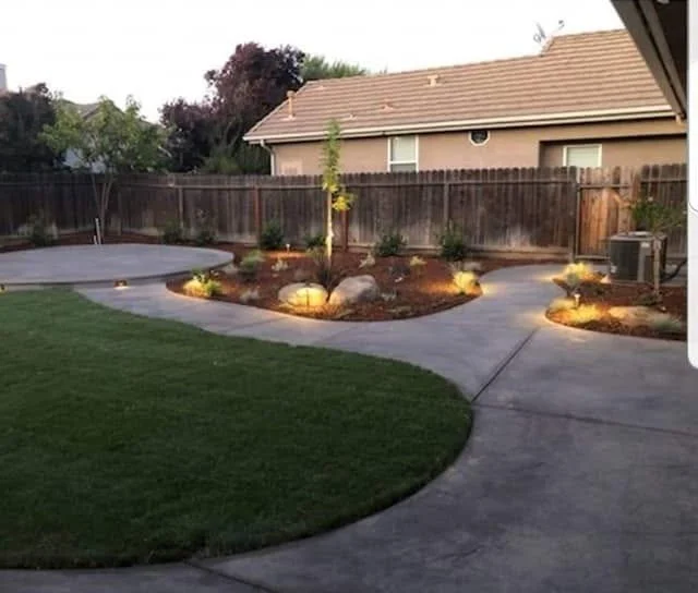 Lawn and planter lighting on a finished landscape lighting job by Specialty Landscape