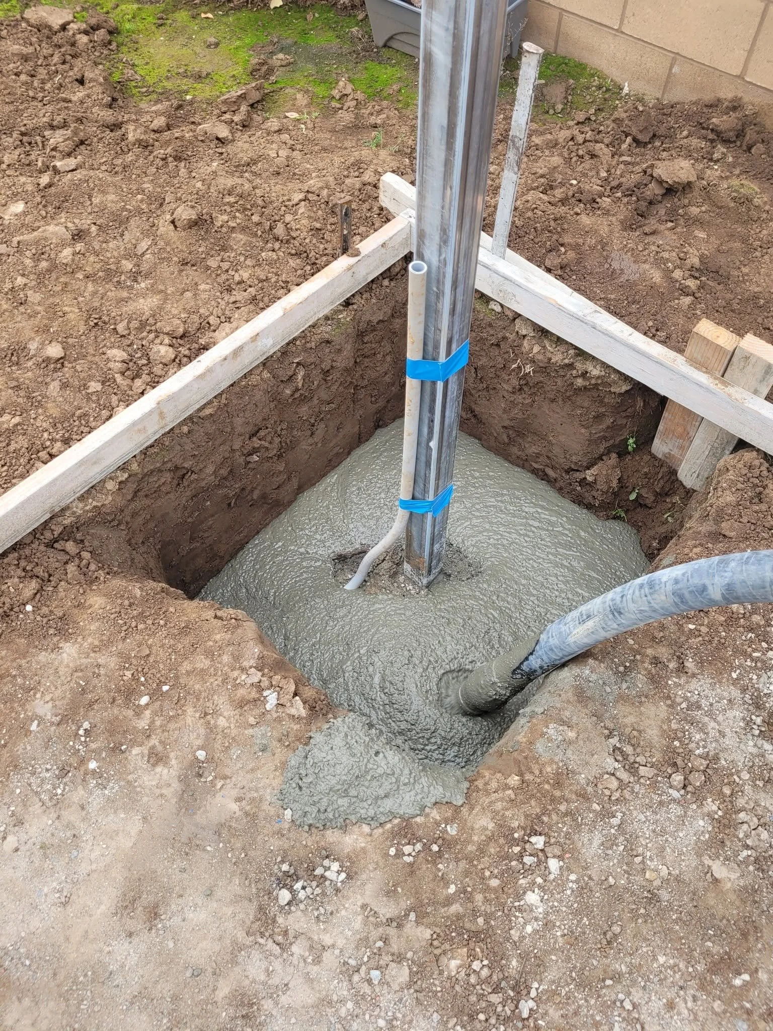 Gravel and pipe French drain set in a trench by Specialty Landscape