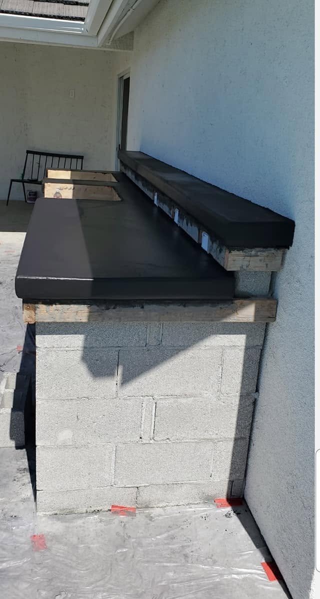 Masonry block island finished with a granite top by Specialty Landscape