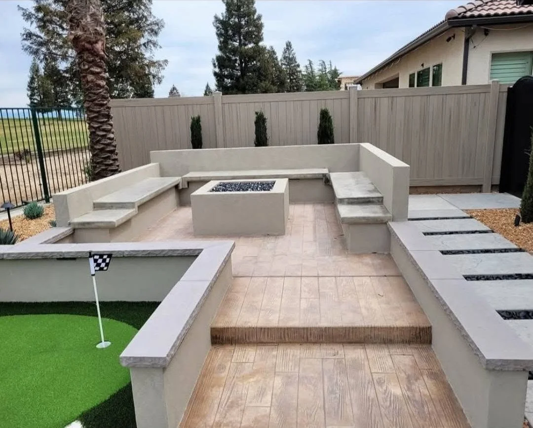 Low masonry seating walls built around a fire pit by Specialty Landscape