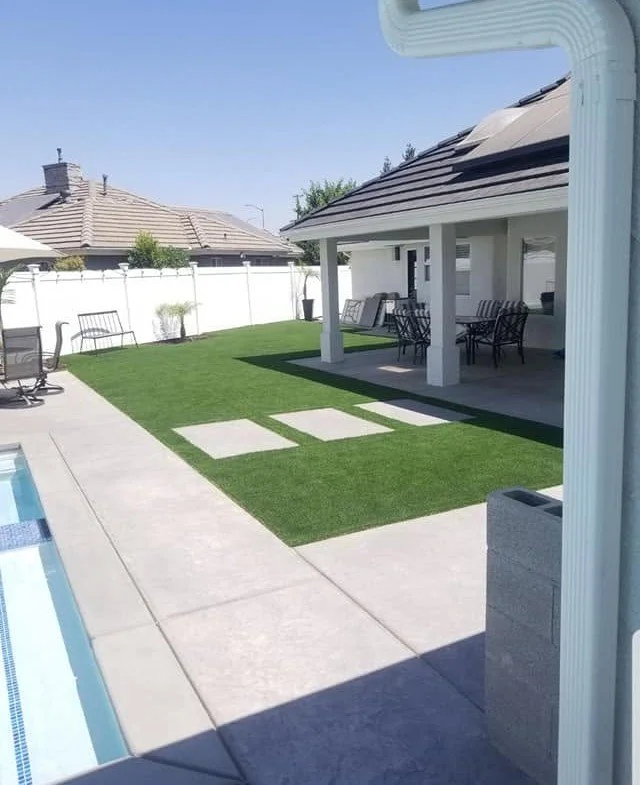 Patio cover giving shade and shelter to an open Kerman backyard by Specialty Landscape