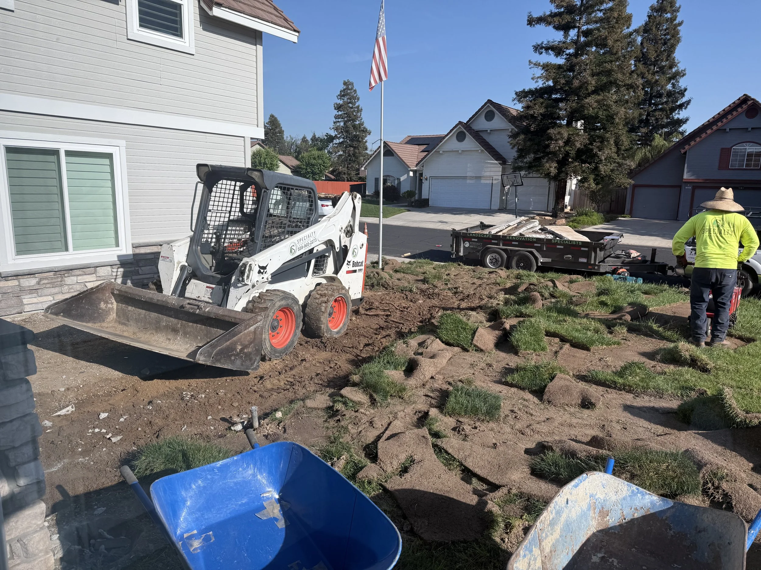 Specialty Landscape skid steer preparing a front yard for a new landscape installation