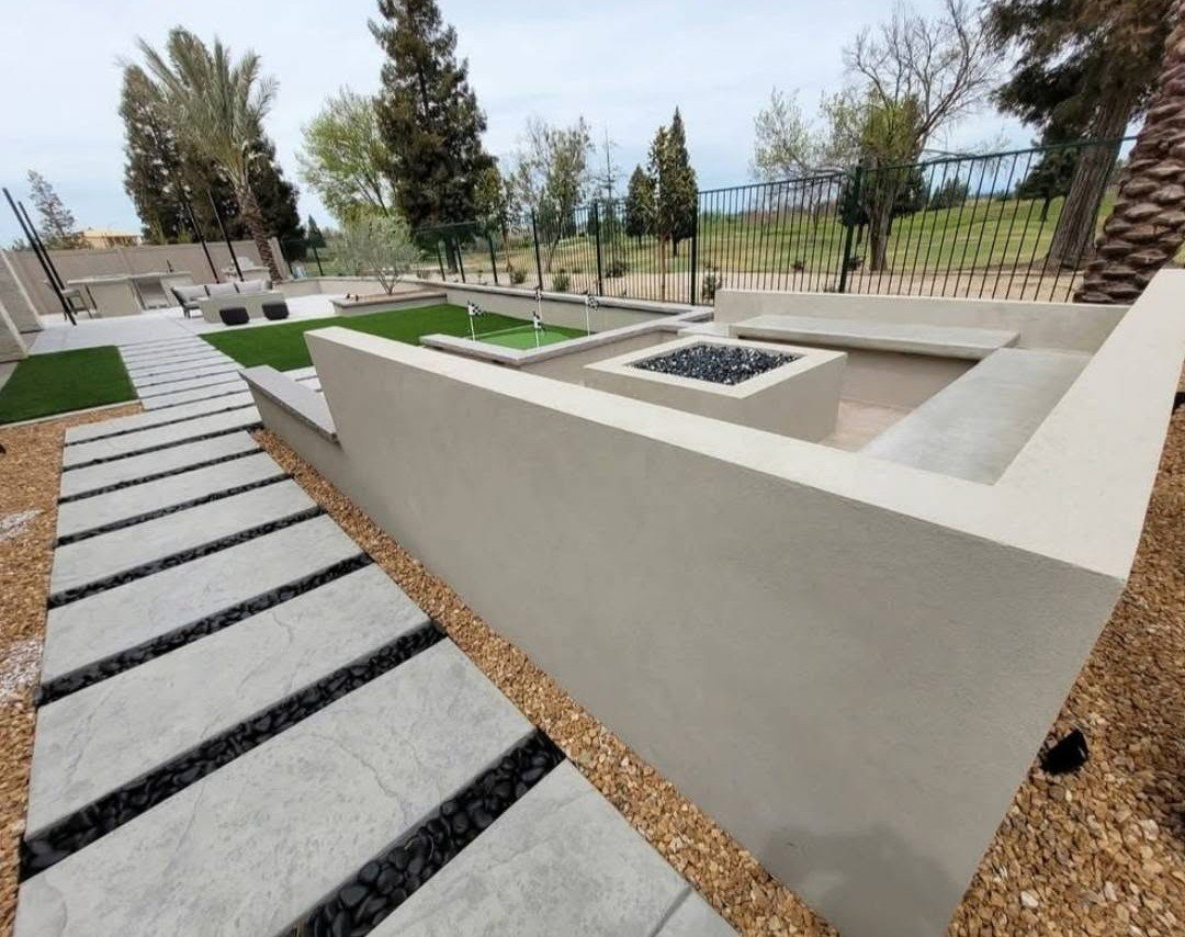 Concrete seat wall and raised planter built by the Specialty Landscape masonry and stonework crew